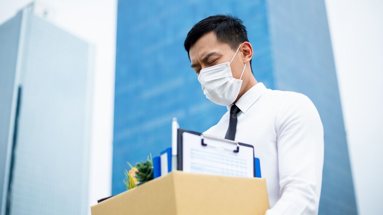 employee carrying box while wearing mask
